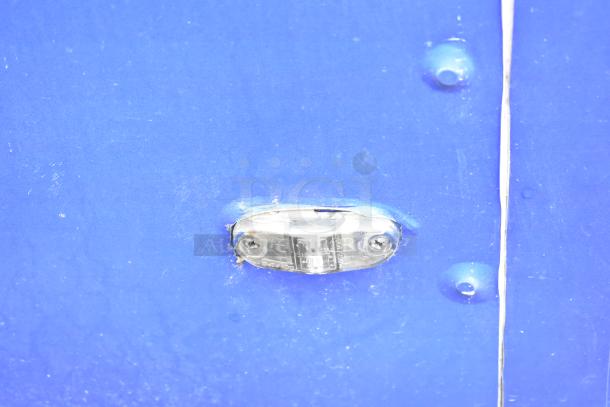 Blue mobile kitchen trailer side detail with visible scratches and minor wear.