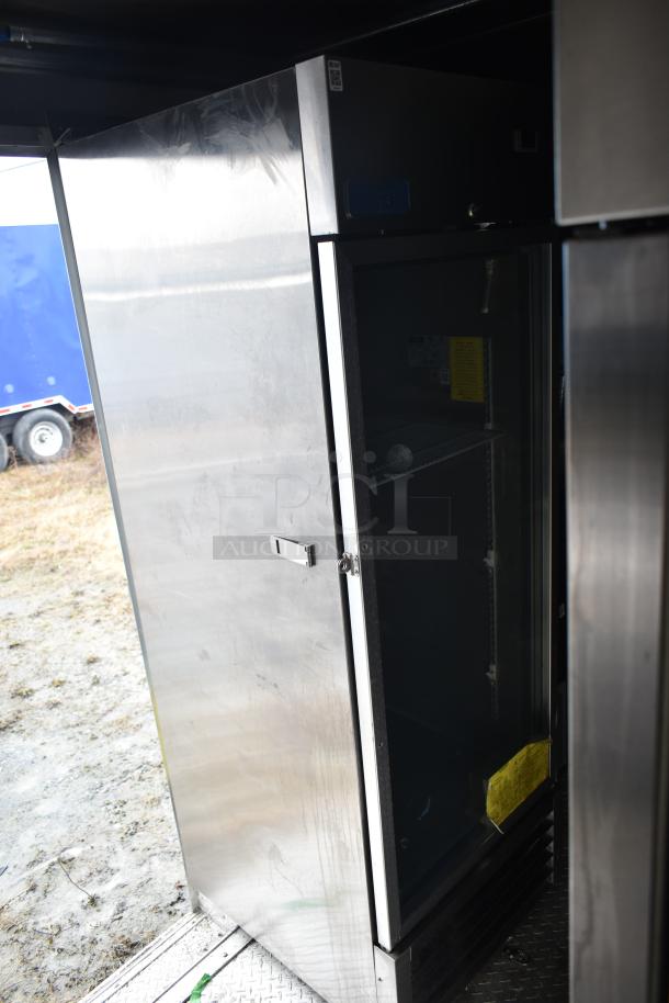 Stainless steel mobile kitchen interior featuring Arctic Air cooler, showing shelving and open door. Rugged and professional design.