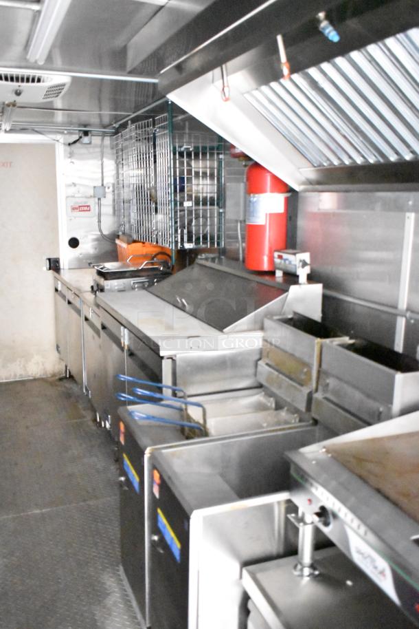 Fully outfitted mobile kitchen trailer with CaptiveAire hood, Pitco fryers, Arctic Air prep tables, and full POS system.
