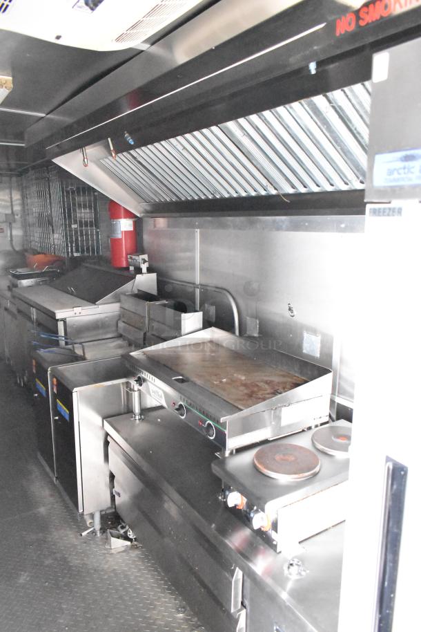 Fully outfitted mobile kitchen trailer with CaptiveAire hood, Pitco fryers, Arctic Air prep tables, air conditioning, and POS system.