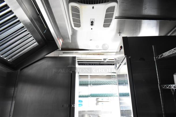 Fully outfitted mobile kitchen trailer interior with CaptiveAire hood, Arctic Air equipment, and air conditioning system.