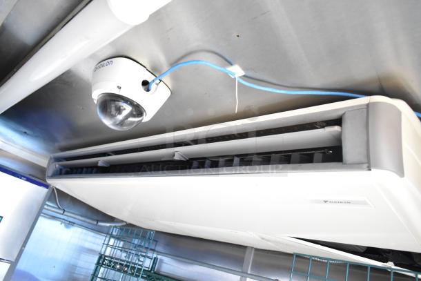 Mobile kitchen interior with a Daikin air conditioning unit and Avigilon security camera, showcasing sophisticated infrastructure.