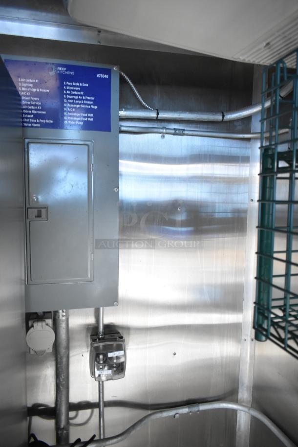 Mobile kitchen trailer interior, featuring electrical panel and wiring. Visible labels indicate kitchen equipment list.