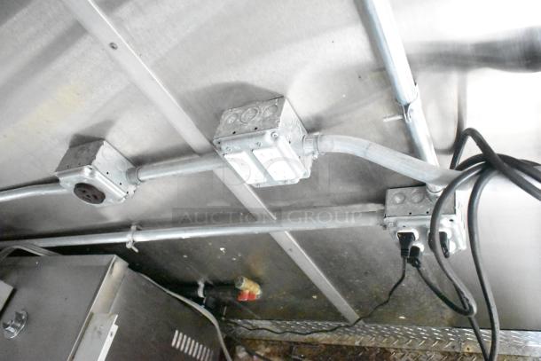 Mobile kitchen trailer wiring and outlets; includes CaptiveAire hood, Pitco fryers, Arctic Air prep tables.