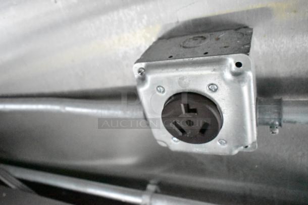 Electrical outlet in mobile kitchen trailer's interior, showcasing robust setup for kitchen equipment.