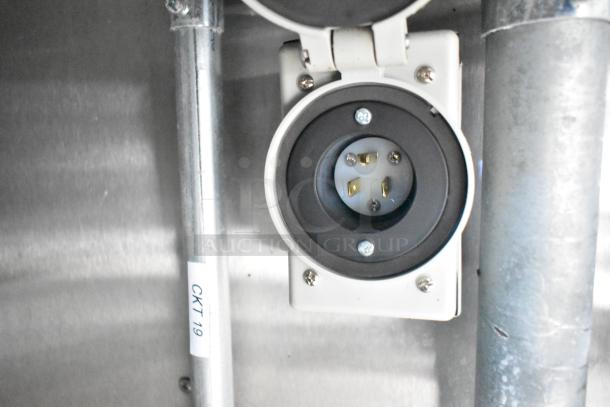 Electrical outlet inside fully outfitted mobile kitchen trailer, labeled "CKT 19." Durable metal and plastic construction.