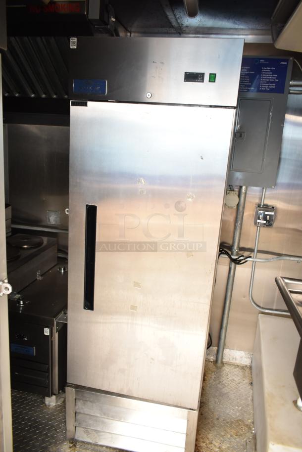 Fully outfitted mobile kitchen trailer with CaptiveAire hood, Arctic Air freezer, visible on diamond plate flooring.