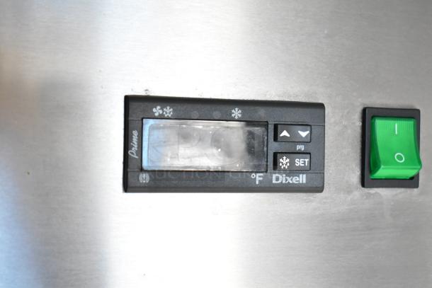 Control panel for a Dixell refrigeration unit with temperature settings and a green power switch, part of a mobile kitchen trailer.