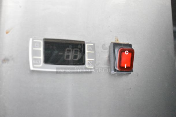 Close-up view of a Dixell digital control panel and red power switch in a mobile kitchen trailer.