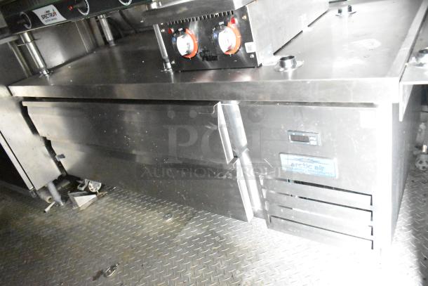 Fully outfitted mobile kitchen trailer with CaptiveAire hood, Arctic Air prep table, and commercial grade equipment.