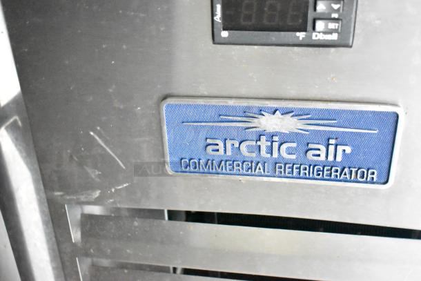Arctic Air commercial refrigerator with visible logo, part of a fully outfitted mobile kitchen trailer.