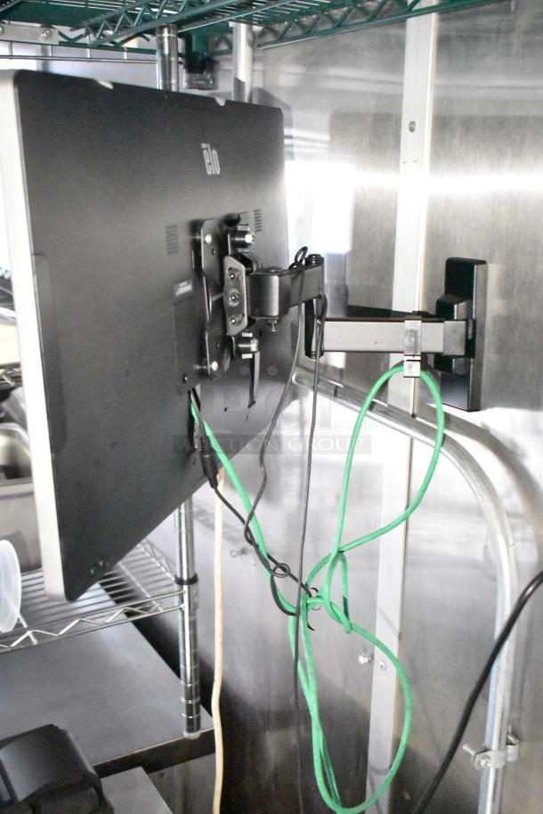 POS system in mobile kitchen trailer with mounting bracket and cables. Part of full POS infrastructure setup.