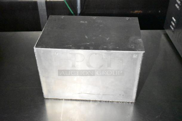 Metallic box on a kitchen trailer surface; purpose and condition not specified.