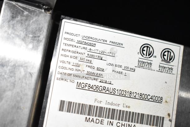 Label on undercounter freezer, Model MGF8406GR, showing specs: Temp -8°F to 1°F, Refrigerant R290, 115V, made in 2018.