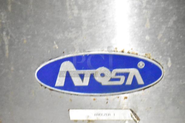 "Image shows an Atosa logo on a metal surface, indicating part of the mobile kitchen trailer containing Atosa freezers."