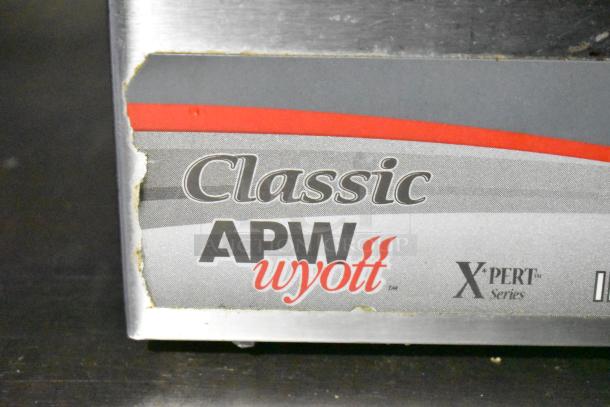 "Classic APW Wyott X*pert Series" label on mobile kitchen equipment, indicating brand and series.