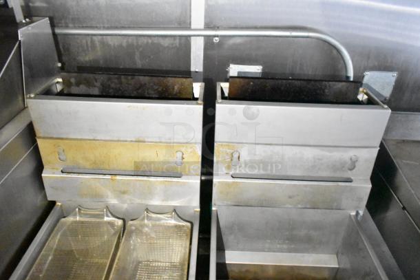 Fully equipped mobile kitchen trailer with CaptiveAire hood, Pitco fryers evident; used, shows wear.