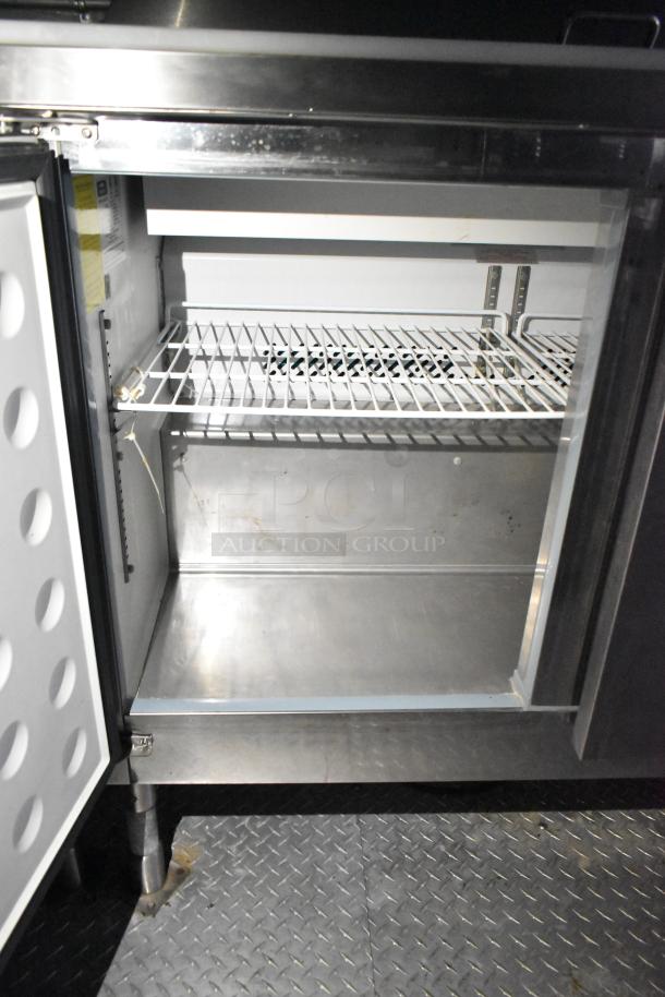 Interior of Arctic Air cooler in a mobile kitchen trailer, showing clean white wire rack and stainless steel finish.
