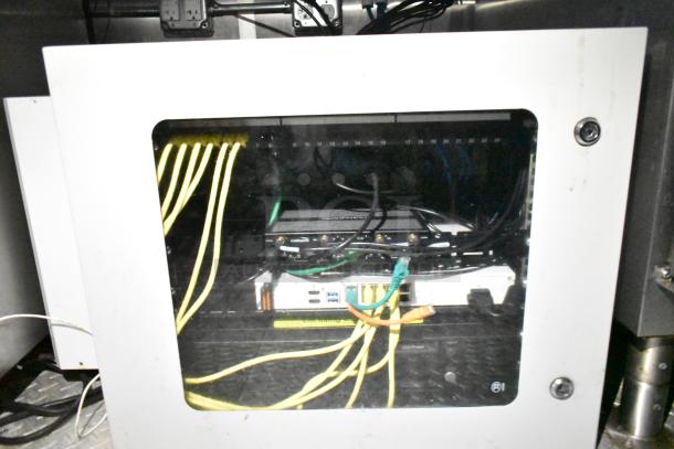 Mobile kitchen trailer network cabinet with visible cables and connections showcasing a technical setup for POS infrastructure.