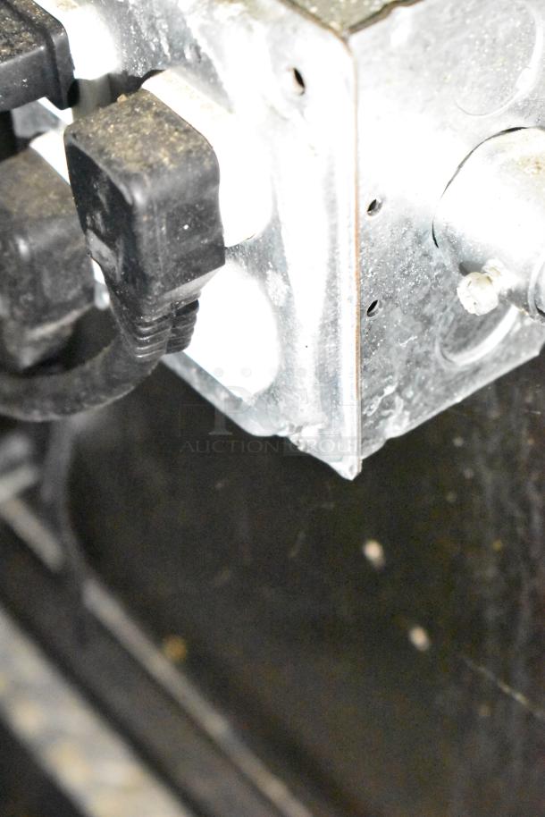 Close-up of electrical outlet in fully outfitted mobile kitchen trailer, featuring CaptiveAire hood and Pitco fryers.