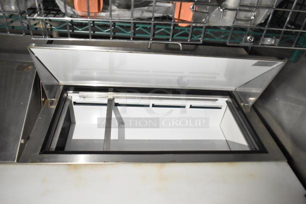 Mobile kitchen trailer interior showing Arctic Air prep table with open lid, stainless steel construction, clean condition.