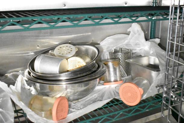 Kitchenware and metal containers in a mobile kitchen trailer, equipped with CaptiveAire hood and Pitco fryers.
