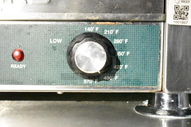 Control dial on mobile kitchen appliance, showing temperature settings from 140°F to 570°F with "Ready" indicator light.