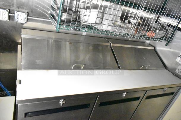 Mobile kitchen trailer with CaptiveAire hood, Arctic Air prep tables, and full POS setup. Stainless steel surfaces shown.