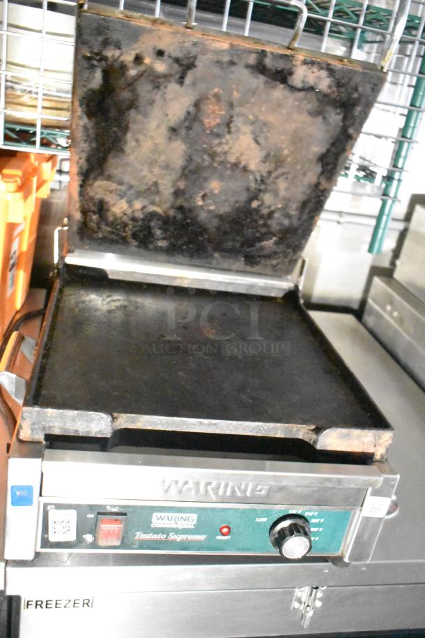 Waring Tostato Supremo appliance, used condition, with visible wear on grilling surfaces, located in mobile kitchen trailer.