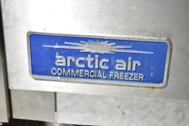 Arctic Air commercial freezer label on a fully outfitted mobile kitchen trailer, featuring CaptiveAire hood and Pitco fryers.