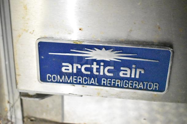 Arctic Air commercial refrigerator label on mobile kitchen trailer. Features CaptiveAire hood, Pitco fryers, Arctic Air prep tables.