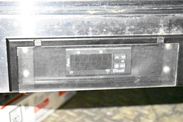 Digital temperature display on a mobile kitchen trailer, showing parameters in Fahrenheit, labelled 'Dixell'.