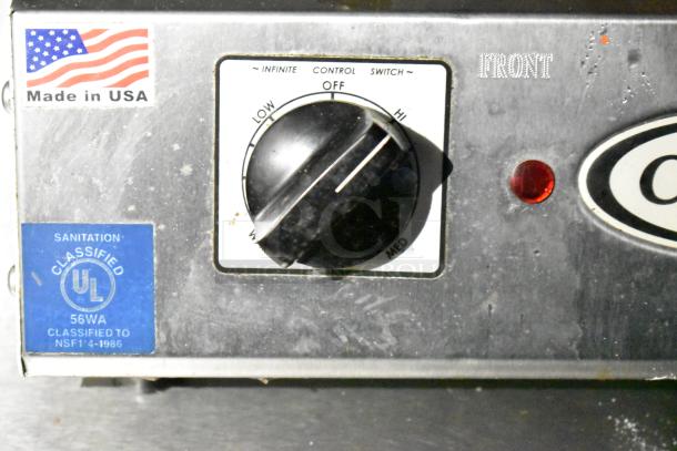 Control panel with American flag sticker "Made in USA," blue UL classified sanitation label, and control switch for mobile kitchen trailer.