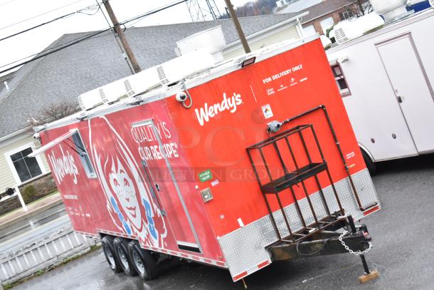 2021 Titanium Cargo 8.5' x 28' Wendy's mobile kitchen trailer, red exterior, triple axle, equipped for food delivery.