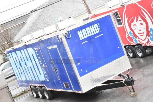 2021 Rock Solid Cargo 8.5' x 28' mobile kitchen trailer, blue NBRHD branding, triple axle, equipped with Nieco broiler and full kitchen suite.