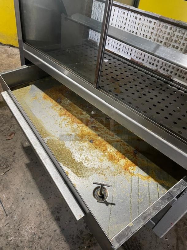 Old Hickory N14G stainless steel rotisserie oven with 14 spits, sliding glass doors, on casters. Shows usage wear.