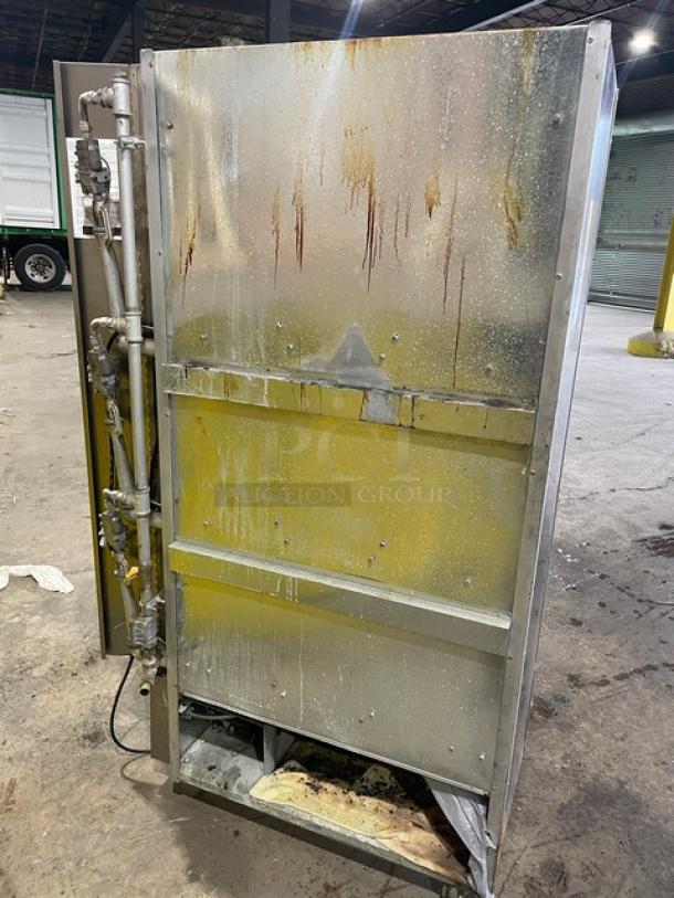 Old Hickory N7GRH commercial stainless steel rotisserie oven, seven spits, natural gas powered, visible wear, on casters.