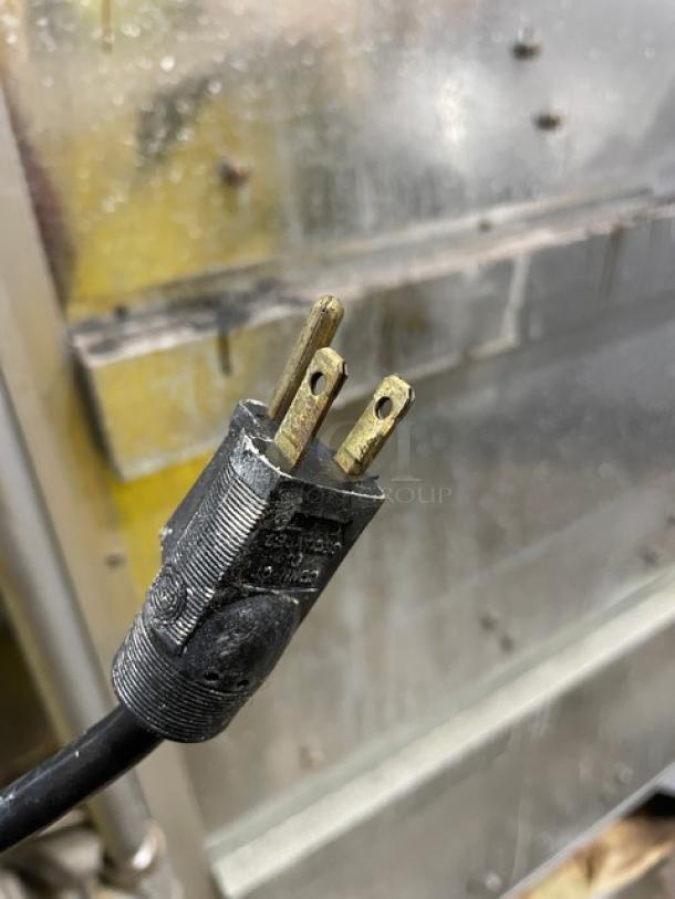 Old Hickory N7GRH rotisserie oven plug, black, connected to stainless steel appliance surface.