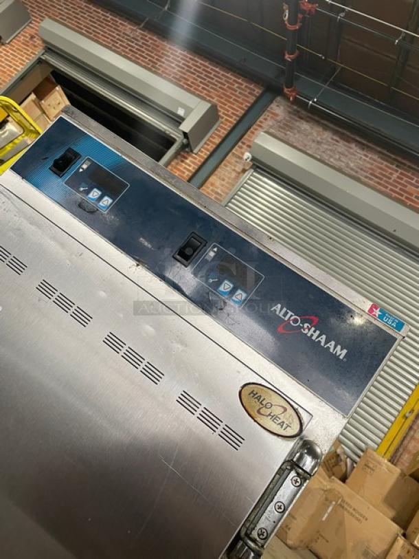 Alto-Shaam 1000-UP commercial stainless steel heated cabinet, dual compartment, on casters, model and logo visible.