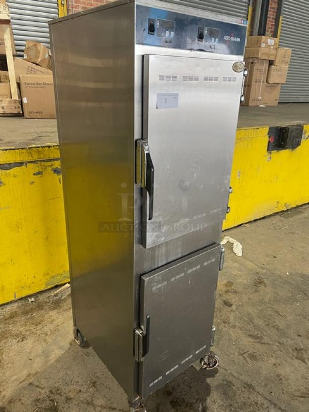 Alto-Shaam 1000UP stainless steel dual compartment heated cabinet on casters. Model 1000-UP, 120V, 1 phase. Serial 1042857-000.