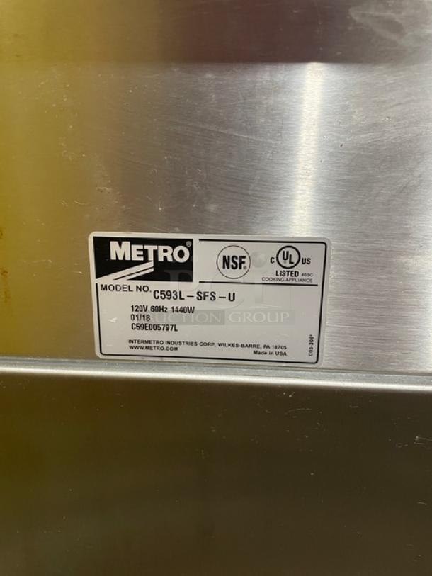 Metro C593L-SFS-U stainless steel undercounter heated cabinet, electric-powered, with universal pan rack and corner bumpers, on casters.