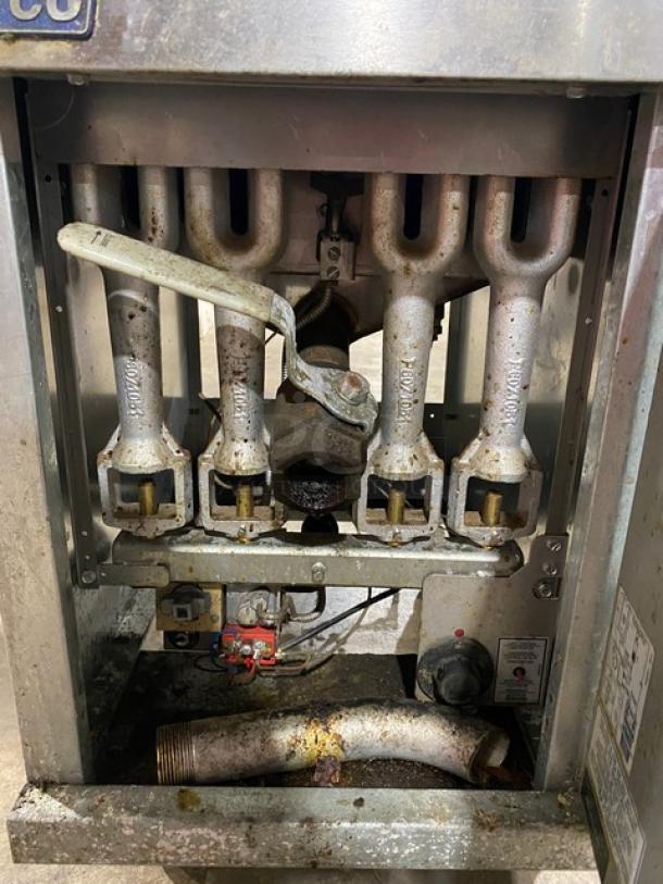 Pitco 45CS commercial stainless steel 42 lb. natural gas fryer, shows burner assembly. Model: 45C-S SN: G16LA085673, on casters.