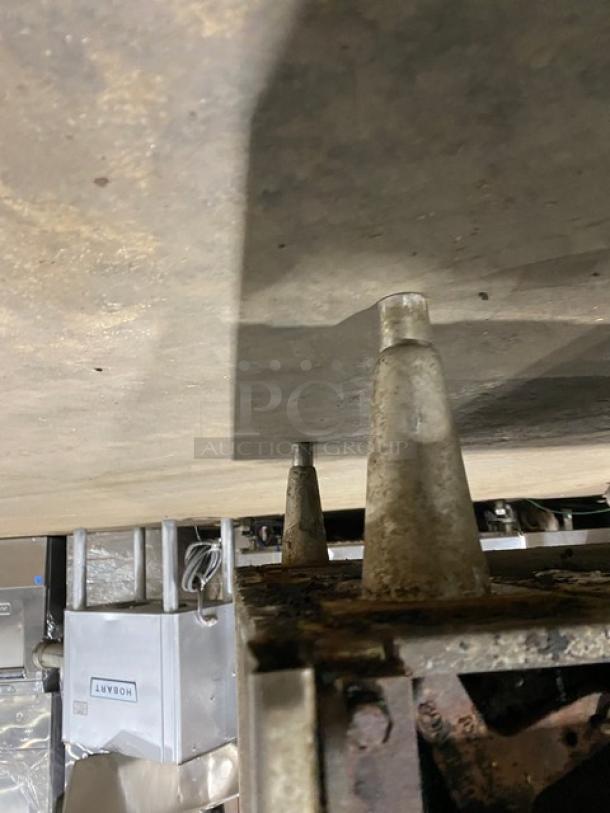 Jade Range stainless steel gas 4-burner char broiler range/oven combo, features backsplash and wired oven rack, on legs.