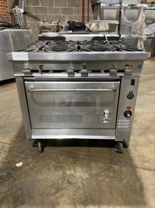 Montague commercial stainless steel gas 6-burner range with convection oven, on casters. Industrial-grade, excellent condition.