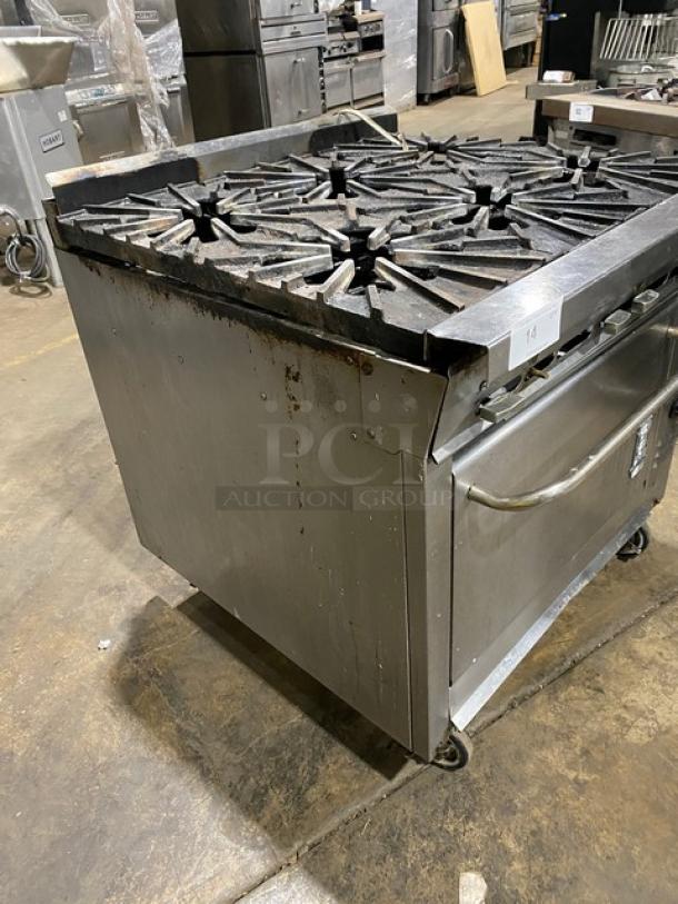Montague commercial stainless steel 6-burner range/convection oven combo on casters, used condition, gas-powered.
