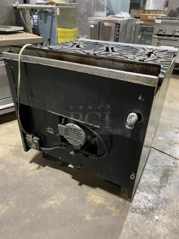 Montague commercial stainless steel 6-burner gas range with convection oven, on casters, used condition.