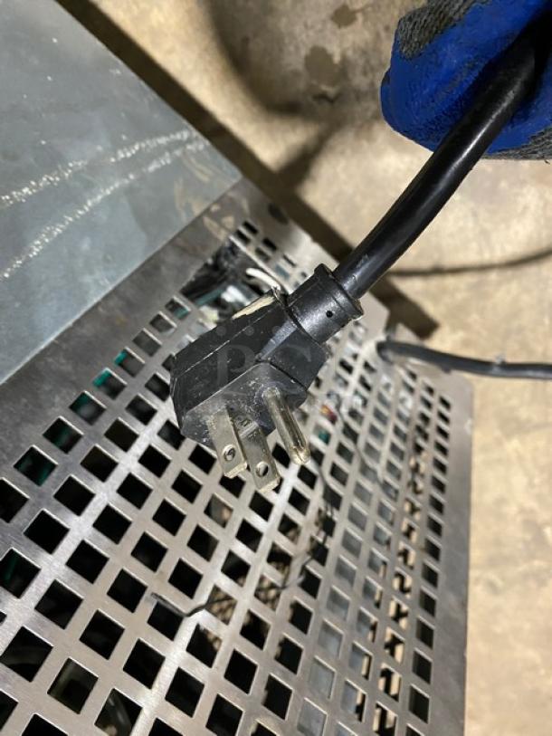 Turbo Air commercial stainless steel chef base, 2-drawer refrigerated unit on casters. Grid surface with power cable visible.