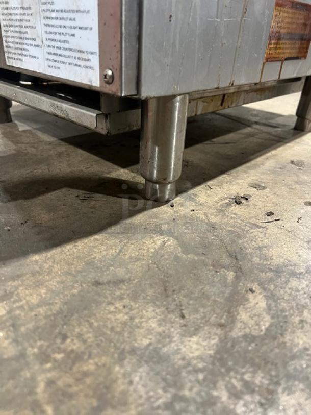 Admiral Craft ECTC16NG char broiler on legs. Stainless steel with cast iron grates. Natural gas powered, model tag visible.