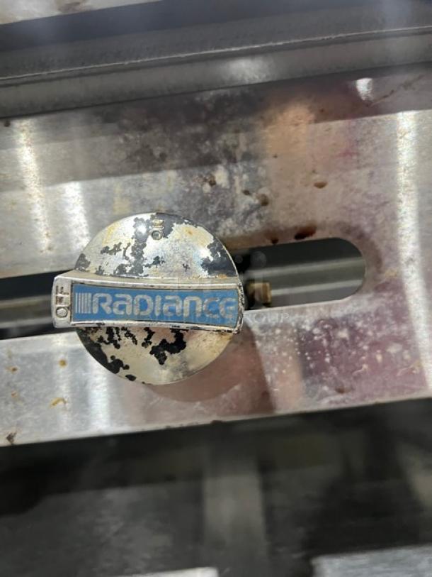 Radiance TAMG36 stainless steel gas griddle knob, visible wear, labeled "Radiance," with on/off settings.