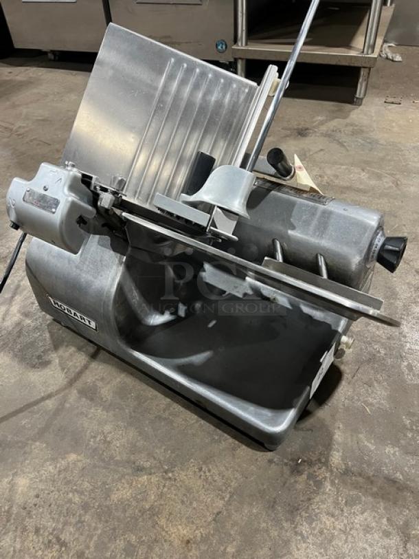 Hobart 1612E commercial deli meat slicer, electric, 220/240V, 1 phase, used condition, visible Hobart logo.